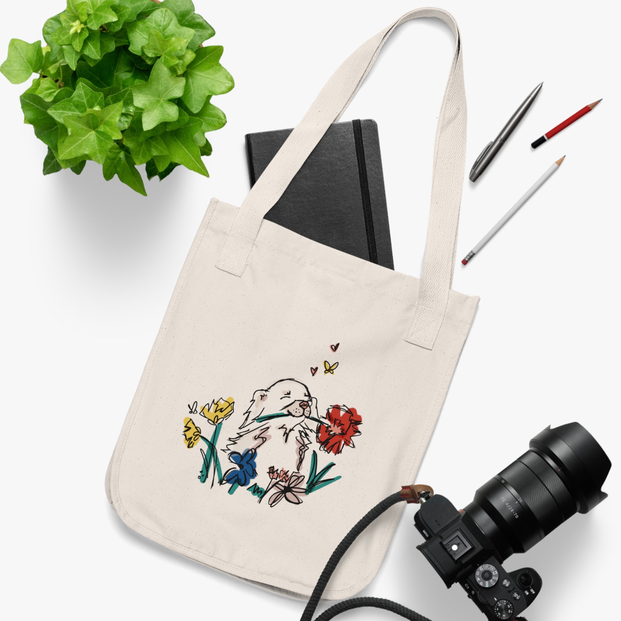 small dog sketch with flowers on an organic cotton tote bag with notebook and camera - unique gifts for dog owners - 100 organic cotton Canvas Tote Bag at sleepy chi - sustainable ecofriendly cute and unique gifts for dog owners